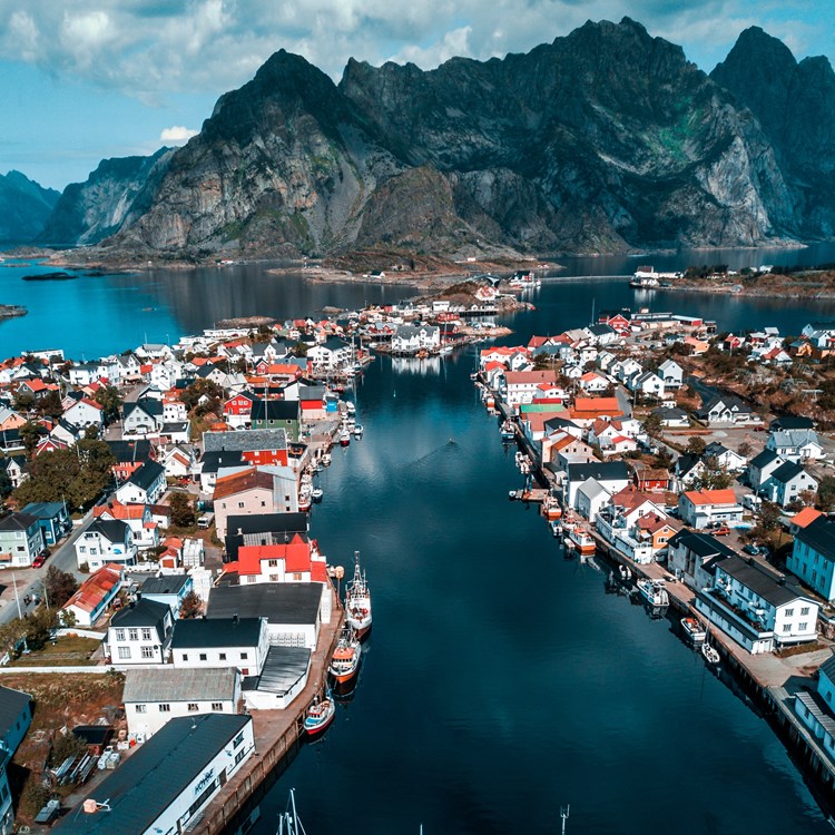 Bild från Norge över en fiskehamn med berg i bakgrunden